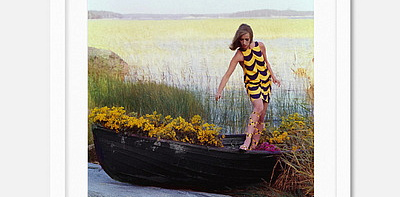 Model In Rowboat Filled With Yellow Flowers Постер